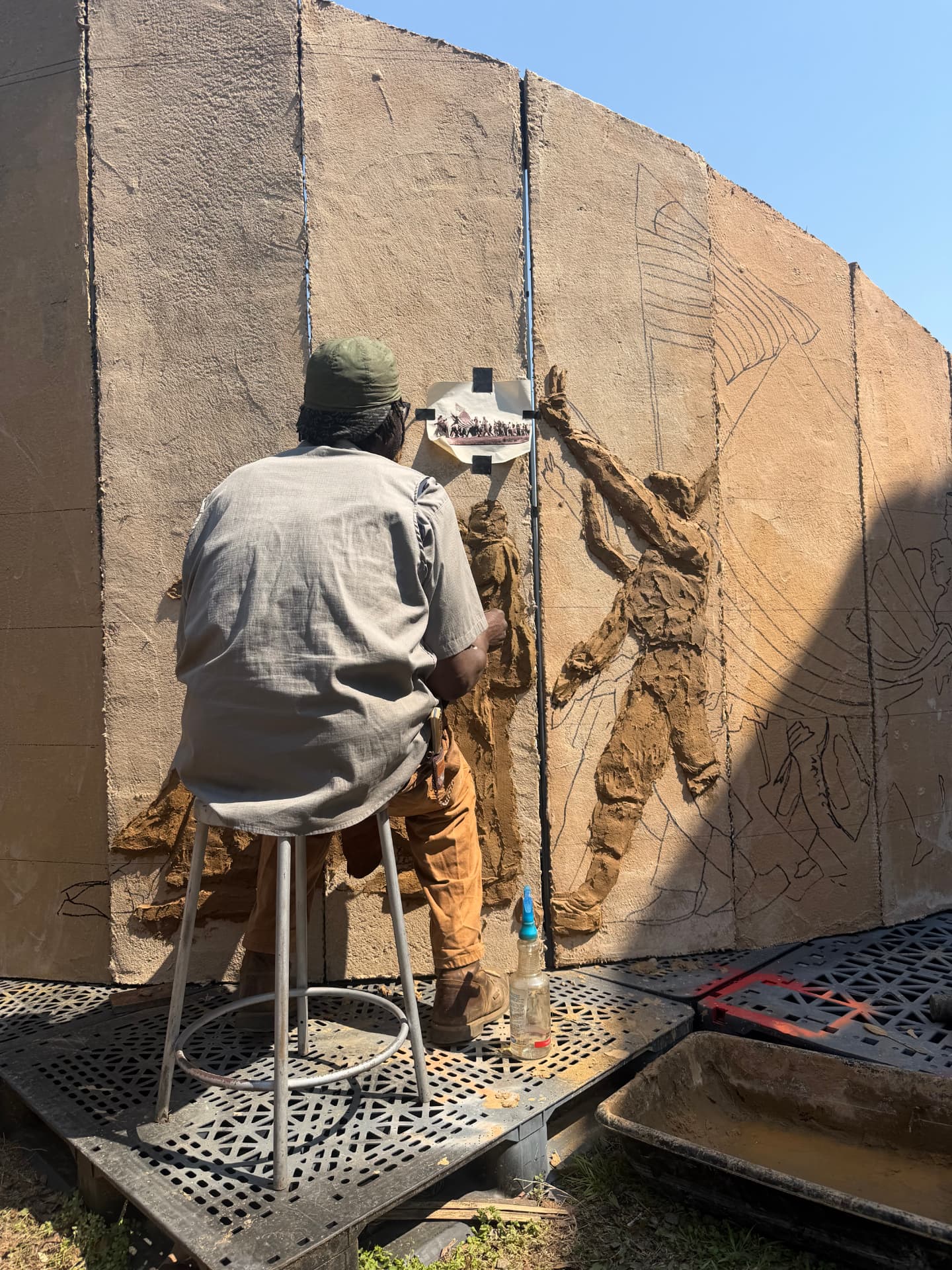 Artist Derrick Monk sculpting the 43 Trailblazers Memorial relief